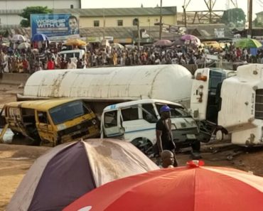 Lady trapped as petrol tanker falls on two busses in Lagos